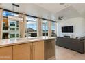 Bright living area with a sleek kitchen island, large windows, and a comfortable seating arrangement at 4747 N Scottsdale Rd # 4009, Scottsdale, AZ 85251