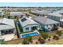 Aerial view of backyard with pool, spa, and artificial grass in a well-maintained neighborhood at 5341 W Alta Mesa Ave, Laveen, AZ 85339