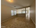 Spacious, light-filled living room with neutral walls, tile flooring, and ample natural light through bright windows at 6341 W Valencia Dr, Laveen, AZ 85339