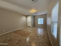 Inviting living room features neutral tones, tile flooring, and large windows with privacy blinds at 6341 W Valencia Dr, Laveen, AZ 85339
