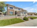 Charming two-story home with a well-maintained lawn and stone accents at 7129 S Stadium Way, Gilbert, AZ 85298