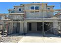 Exterior shot of a gray home under construction showcasing scaffolding and incomplete features at 7393 W Buckhorn Trl, Peoria, AZ 85383