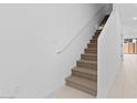 Interior view of the carpeted stairway with a white handrail and white walls at 7434 S 75Th Dr, Laveen, AZ 85339
