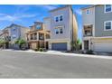 Modern townhomes featuring two-story designs with attached garages and landscaped front yards at 751 W Flintlock Way, Chandler, AZ 85286