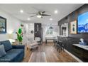 Open-concept living room with hardwood floors, modern furniture, and eat-in breakfast bar at 7625 E Camelback Rd # 310B, Scottsdale, AZ 85251