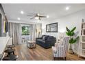 Comfortable living room featuring modern furnishings, hardwood floors and balcony access at 7625 E Camelback Rd # 310B, Scottsdale, AZ 85251
