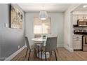 Cozy dining room with modern light fixture and gray and white color palette at 7625 E Camelback Rd # A139, Scottsdale, AZ 85251
