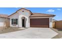 Attractive single-story home displaying a tile roof, stucco facade and a spacious two-car garage at 7638 W Park St, Laveen, AZ 85339