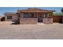 Charming single-story home featuring a stone accent wall and covered front porch at 7930 E Broadway Rd, Mesa, AZ 85208