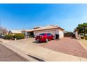 Beautiful single-Gathering home with desert landscaping, three-car garage, and modern exterior at 8053 E Dover St, Mesa, AZ 85207