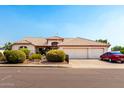 Charming single-Gathering home boasts a three-car garage, well-maintained landscaping, and a welcoming facade at 8053 E Dover St, Mesa, AZ 85207