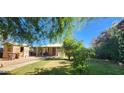 Well-kept home with lush greenery and a cozy covered porch at 8527 W Jefferson St, Peoria, AZ 85345
