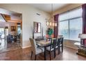Charming dining room with stylish chandelier, modern decor, and large window for natural light at 965 E Virgo Pl, Chandler, AZ 85249