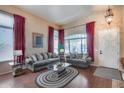 Cozy living room with hardwood floors, ample natural light, and comfortable seating arrangement at 965 E Virgo Pl, Chandler, AZ 85249