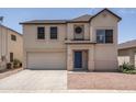 Two-story home featuring a two-car garage, blue door, and desert landscaping at 12424 N B St, El Mirage, AZ 85335