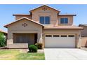 Exterior front view of a two-story home featuring a two-car garage and desert landscaping at 12426 W Adams St, Avondale, AZ 85323