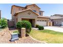 Two-story home with desert landscaping, a two-car garage and well-maintained lawn at 12426 W Adams St, Avondale, AZ 85323