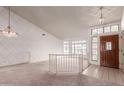 Open-concept living area featuring large windows, a decorative chandelier, a light color scheme, and tile entryway at 1258 E Granada St, Mesa, AZ 85203