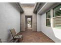 Cozy courtyard featuring a brick floor, seating area, and entry to the home at 14177 W Calle Lejos --, Surprise, AZ 85387