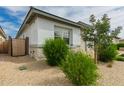 Home exterior with desert landscaping, side gate, and textured stucco walls at 14177 W Calle Lejos --, Surprise, AZ 85387