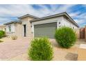 A single-Gathering home featuring desert landscaping and a two-car garage at 14177 W Calle Lejos --, Surprise, AZ 85387