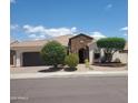 Charming single-story home with desert landscaping, a stone archway and attached two-car garage at 14725 S 182Nd Dr, Goodyear, AZ 85338