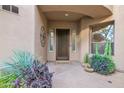 Inviting front porch with decorative plants and stylish front door at 15240 N Clubgate Dr # 168, Scottsdale, AZ 85254