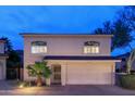 Front exterior of a two-story home featuring a two-car garage, secure entry, and desert landscaping at 15550 N Frank Lloyd Wright N Blvd # 1040, Scottsdale, AZ 85260