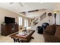 Cozy living room featuring comfortable seating, an entertainment center, and a staircase with ornate railing at 15550 N Frank Lloyd Wright N Blvd # 1040, Scottsdale, AZ 85260