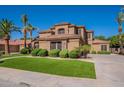 Beautiful home featuring lush green lawn with attractive desert landscaping at 1808 S Sailors Way, Gilbert, AZ 85295