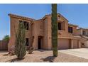Inviting two-story home featuring a two-car garage and desert-friendly landscaping at 18903 N Shelby Dr, Maricopa, AZ 85138