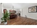 Spacious dining area featuring hardwood floors, chandelier, and large cabinet at 18903 N Shelby Dr, Maricopa, AZ 85138