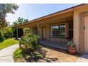 Inviting front porch with decorative potted plants enhances this home's curb appeal at 19006 E Karsten Dr, Queen Creek, AZ 85142