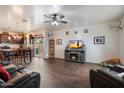 Open-concept living space featuring modern flooring, a ceiling fan, and access to a well-equipped kitchen at 2004 E Heartwood Ln, Phoenix, AZ 85022