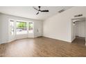 Bright living room with fan, showing flooring and front door at 2124 E Boston St, Chandler, AZ 85225