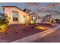 Inviting home exterior showcasing desert landscaping, walkway lighting, and attached garage at 21449 W Mariposa St, Buckeye, AZ 85396