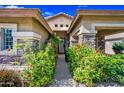 Inviting front entrance framed by desert landscaping with vibrant flowers and stone accents at 2156 W Periwinkle Way, Chandler, AZ 85248