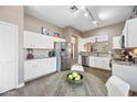 Bright eat-in kitchen featuring white cabinets, stainless steel appliances, and stylish countertops at 2156 W Periwinkle Way, Chandler, AZ 85248