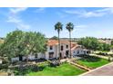 Expansive two-story home features a terracotta roof, mature trees, and a well-manicured lawn at 2339 E Virgo Pl, Chandler, AZ 85249