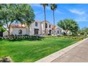 Inviting two-story home with a spacious lawn, mature trees, and a classic terracotta roof at 2339 E Virgo Pl, Chandler, AZ 85249