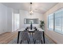 Formal dining room showcasing modern light fixture, marble table, and neutral accents at 23676 W Parkway Dr, Buckeye, AZ 85326