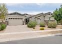 Charming single-story home with a three-car garage, desert landscaping, and a warm, inviting curb appeal at 2513 E Pleasant Ln, Phoenix, AZ 85042