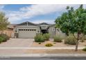 Charming single-story home with a three-car garage, desert landscaping, and a warm, inviting curb appeal at 2513 E Pleasant Ln, Phoenix, AZ 85042