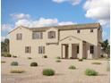 Expansive two-story home showcasing a stucco exterior, tiled roof, and a spacious front yard with desert landscaping at 26205 N 19Th Ln, Phoenix, AZ 85085