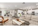 Open concept living space featuring a modern kitchen, dining area, and comfortable seating at 29491 N 122Nd Gln, Peoria, AZ 85383