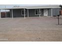 Charming single-story home with a covered carport featuring a low maintenance gravel yard at 329 N 83Rd Pl, Mesa, AZ 85207