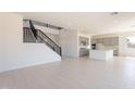 Open concept living space flows to the modern kitchen with grey cabinets at 35234 N Barley St, San Tan Valley, AZ 85144