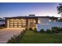 Beautiful home with a modern design, featuring a multi-car garage and well-maintained landscaping at 3626 N Mohave Way, Scottsdale, AZ 85251