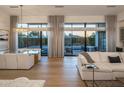 Bright living area with large glass doors providing views to the backyard and pool at 3626 N Mohave Way, Scottsdale, AZ 85251