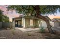 Charming single-story home featuring desert landscaping, a stone pathway, and a cozy covered porch at 4073 E Stable Ct, Gilbert, AZ 85297